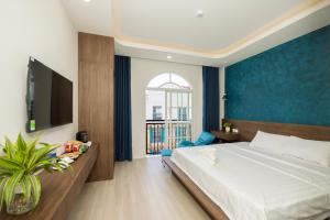 Postel nebo postele na pokoji v ubytování Tiamo Hotel