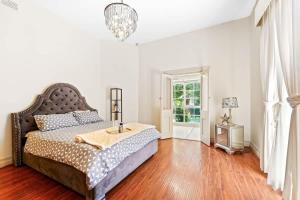 a bedroom with a bed with a table on it at Prime Glen Huntly Beauty - 4BR Family Home w pool in Melbourne