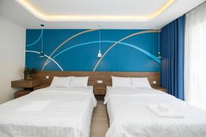 Postel nebo postele na pokoji v ubytování Tiamo Hotel