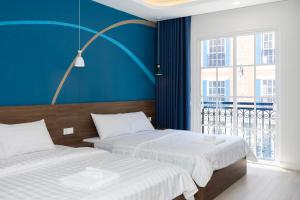 Postel nebo postele na pokoji v ubytování Tiamo Hotel