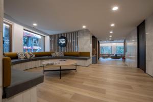 a lobby with a couch and a table at Hotel Comtes d'Urgell by Nexta in Andorra la Vella