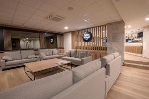 a waiting room with couches and a table in a building at Hotel Comtes d'Urgell by Nexta in Andorra la Vella +20 photos