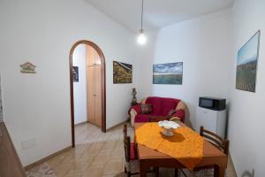 a living room with a table and a couch at Domus61 in Marsala