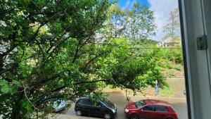 two cars parked in a parking lot outside a window at Retreat Apartment in Tîrgu Ocna