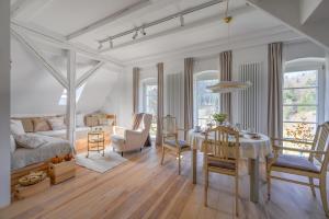 a living room with a table and a dining room at Butikowe apartamenty w Sudetach - TRZY MORZA - pod górą Trójmorski Wierch in Jodłów