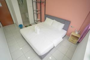 Postel nebo postele na pokoji v ubytování Gemilang Hotel Klang