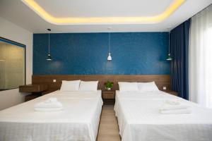 Postel nebo postele na pokoji v ubytování Tiamo Hotel