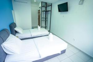 Postel nebo postele na pokoji v ubytování Gemilang Hotel Klang