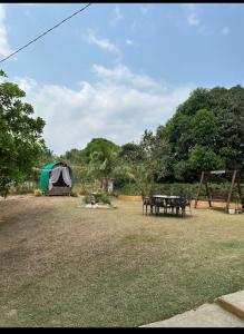 a tent and a picnic table in a field at KEHLANI Vacation Farmhouse in Hermosa +15 photos