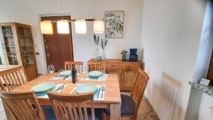 a dining room with a wooden table and chairs at Residenza La Rocca in Castello Valsolda