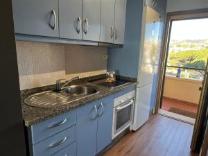 a kitchen with a sink and a counter top at Calypso Holidays in Sitio de Calahonda