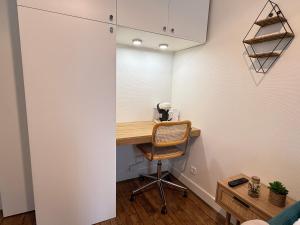 a room with a desk and a chair at Le Petit Nid - cozy comfort close to Paris in Clichy +5 photos