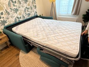 a mattress on top of a bed in a room at Le Petit Nid - cozy comfort close to Paris in Clichy