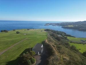 una vista aerea di un campo da golf vicino all'acqua di Dunmore East Ocean View Suite a Dunmore East