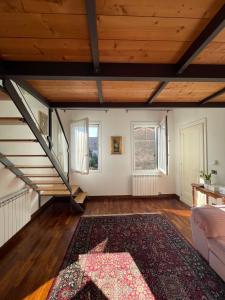 an attic room with a staircase and a rug at Elena Casa Turistica in Padova