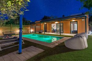 a house with a swimming pool in the yard at Galene Eco Luxury Villas in Acharavi