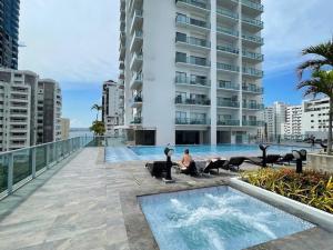 a person sitting in a chair in front of a building at Prity Apartamento in Cartagena de Indias