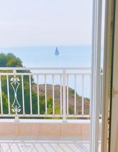 a balcony with a view of the ocean at KALAMIES - Secluded Beach Apartments in Skala +38 photos