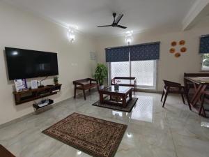 a large living room with a flat screen tv at Best 2x3BHK Premium Homestay - Emerald, 7 Elysee Homestay in Trichūr