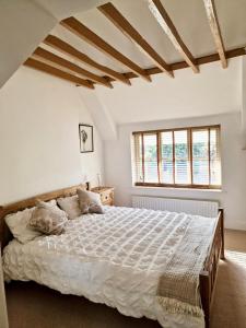 FinchampsteadにあるSpacious Double Bed Room Ensuite & Onsite Parkingの白いシーツが敷かれた大きなベッドのある寝室