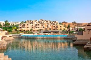 a large body of water with buildings in the background at The Cove Rotana Resort - Ras Al Khaimah in Ras al Khaimah