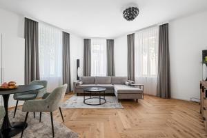 a living room with a couch and a table at easy-flat Rokitanskygasse - Apartments near Tram 43 to City Center in Vienna