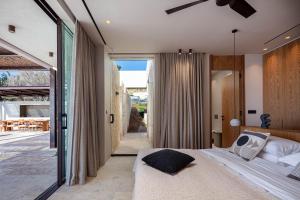 a bedroom with a bed and a sliding glass door at Jamyti Villa in Sellía +72 photos