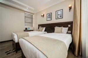 Postel nebo postele na pokoji v ubytování Hemak Suites Hotel