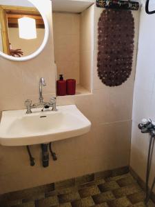 a bathroom with a sink and a mirror at Beliotis' House in Apérathos