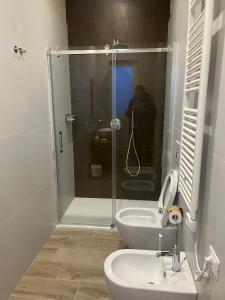 a bathroom with a shower and a toilet and a sink at Archè Agriturismo in Gioia del Colle