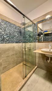 a bathroom with a glass shower and a sink at Azur Dream by the Sea in Hurghada