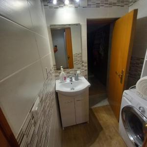 a bathroom with a sink and a washing machine at rismondi 37 in Bari
