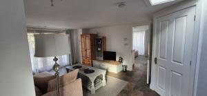 a living room with a couch and a table at Oak Tree Rooms LTD in Brockenhurst +24 photos