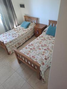 two beds sitting next to each other in a room at posada acevedo in Acevedo