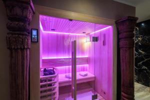 a pink shower with a pink lighting in a room at pampa-chambre-hote et spa in Warhem