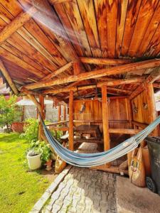 a hammock in the middle of a wooden building at Vila Craita Zarnesti in Zărneşti