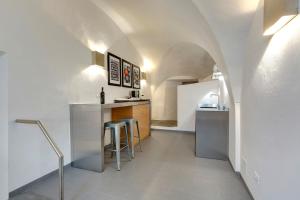 a kitchen with a counter and a bar with stools at B&B Dell'Olio in Florence