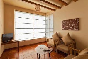Uma televisão e/ou sistema de entretenimento em K Tree Boutique Hotel, Kolhapur