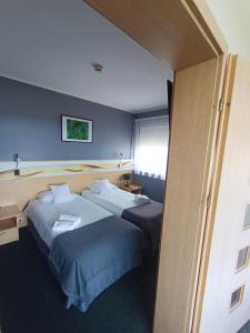 Postel nebo postele na pokoji v ubytování Quality Silesian Hotel