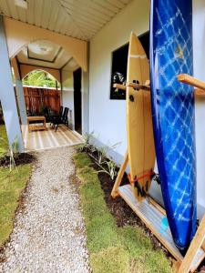 a surfboard sitting on a stand next to a house at Miraflores - Seaside Villa with private Garden in Siargao in General Luna