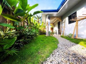 a house with a gravel path next to a house at Miraflores - Seaside Villa with private Garden in Siargao in General Luna