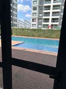 a view of a swimming pool through a window at Lex Place Syokimau in Syokimau
