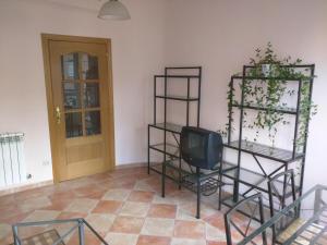 a room with shelves with a tv and a door at San Roque 18 in Santo Domingo de la Calzada