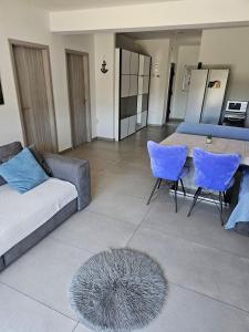 a living room with a couch and a table and chairs at Villa AS MOON with pool in Split