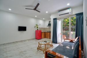 a living room with a couch and a table at Baga Creek Side Nest in Baga
