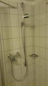a shower with a shower head in a bathroom at FeWo 12 45qm bis 3 Pers nahe Winterberg in Schmallenberg