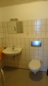 a bathroom with a toilet and a sink at FeWo 12 45qm bis 3 Pers nahe Winterberg in Schmallenberg