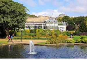 a fountain in a garden in front of a building at Large Victorian Townhouse in Buxton