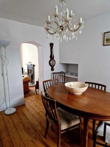 a dining room with a wooden table and a chandelier at Large Victorian Townhouse in Buxton