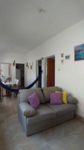 a living room with a couch and a hammock at Hostel Miscelânea in Sete Lagoas